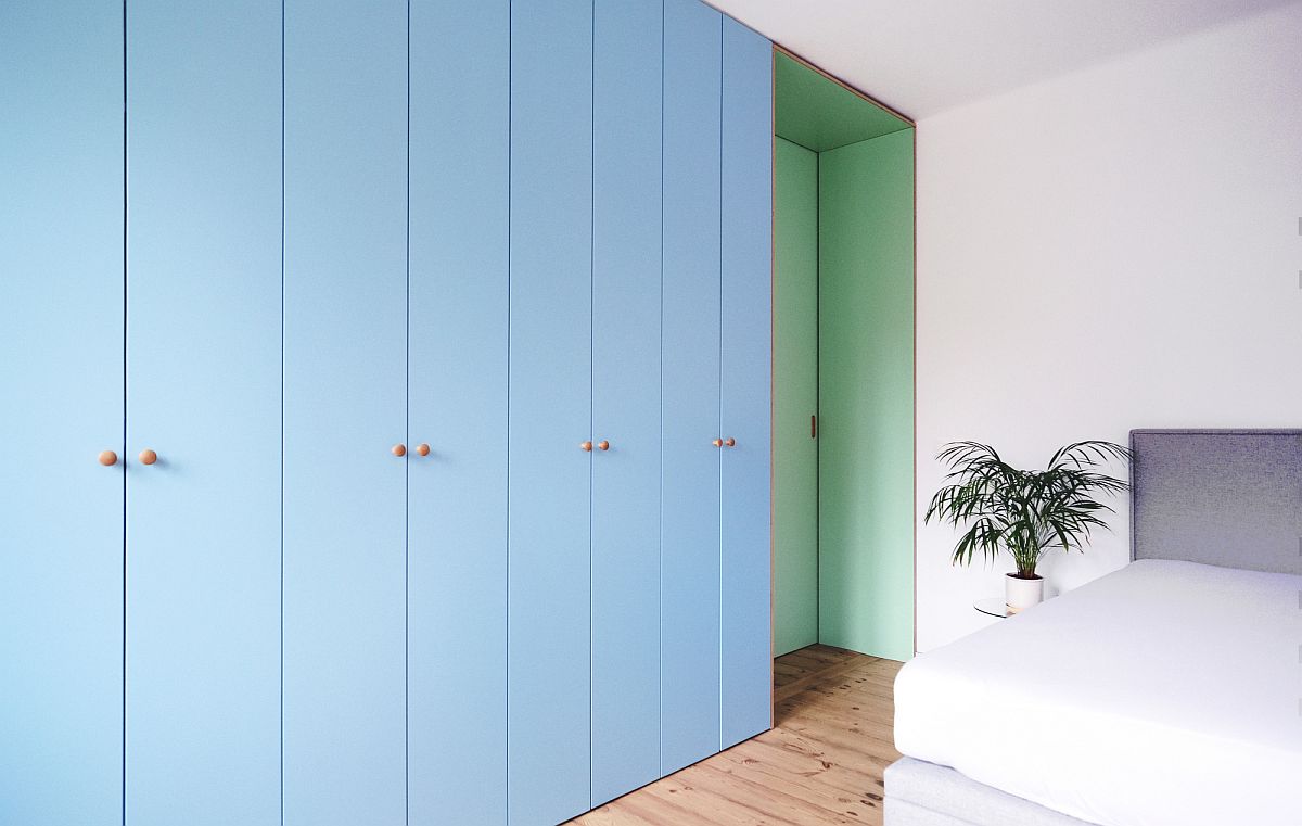 Light blue cabinets coupled with sea green sliding door inside the bedroom