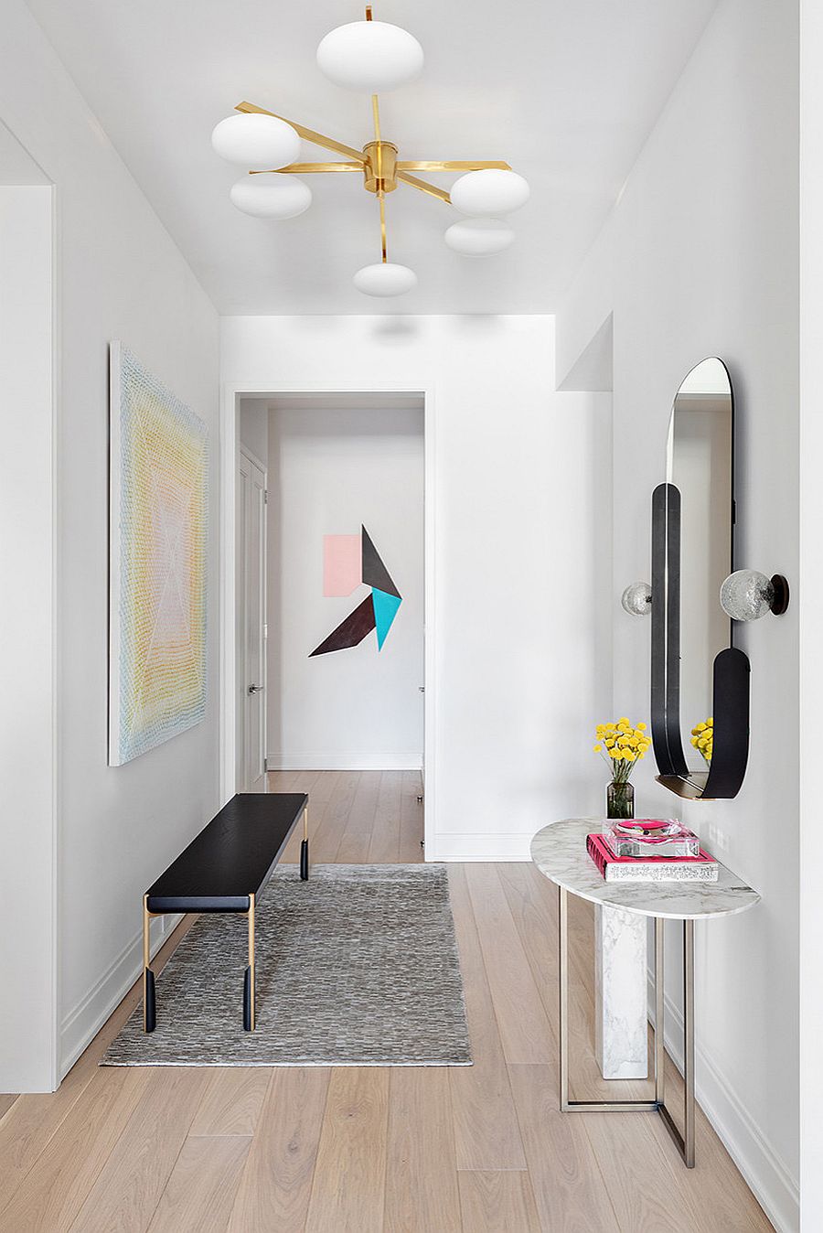 Mirror, fabulous console table and another slim bench are used to decorate this smart hallway