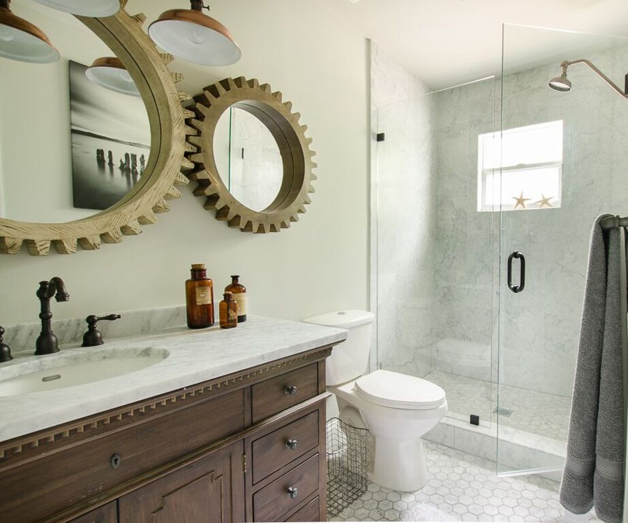Mirror frames and lighting fixtures give the modern bathroom an industrial appeal