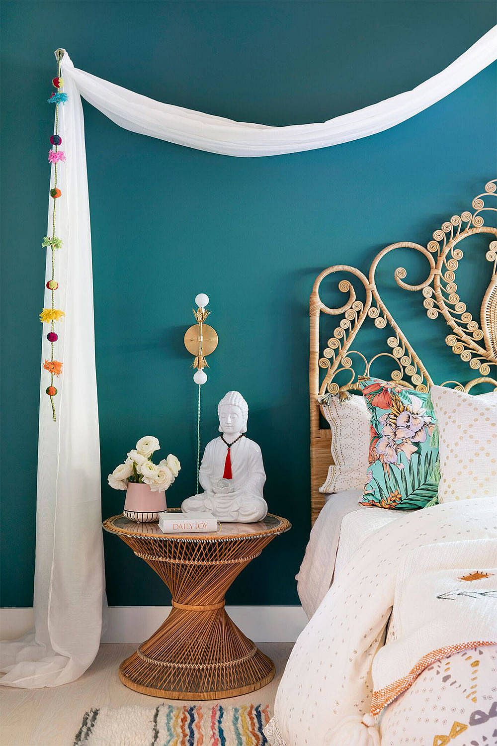 Bohemian-styled bedroom with teal painted walls.