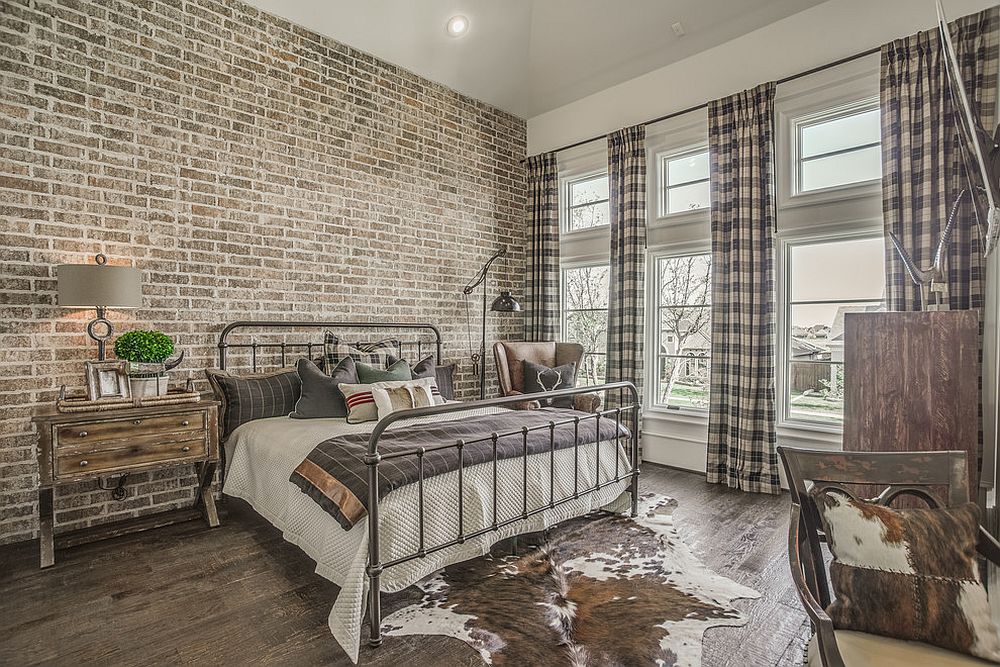 Modern industrial bedroom with exposed brick wall and cutains with plaid pattern