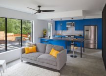 Modern-kitchen-inside-he-Texas-home-with-bright-blue-cabinets-and-a-relaxing-sitting-area-next-to-it-20855-217x155