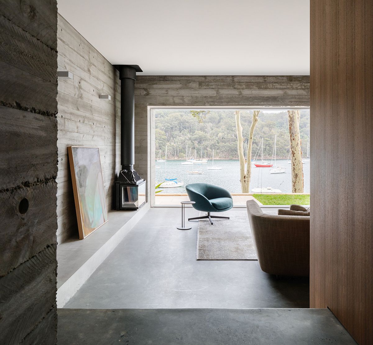 Modern minimal living room of the Church Point House in Sydney with exposed concrete and cement walls