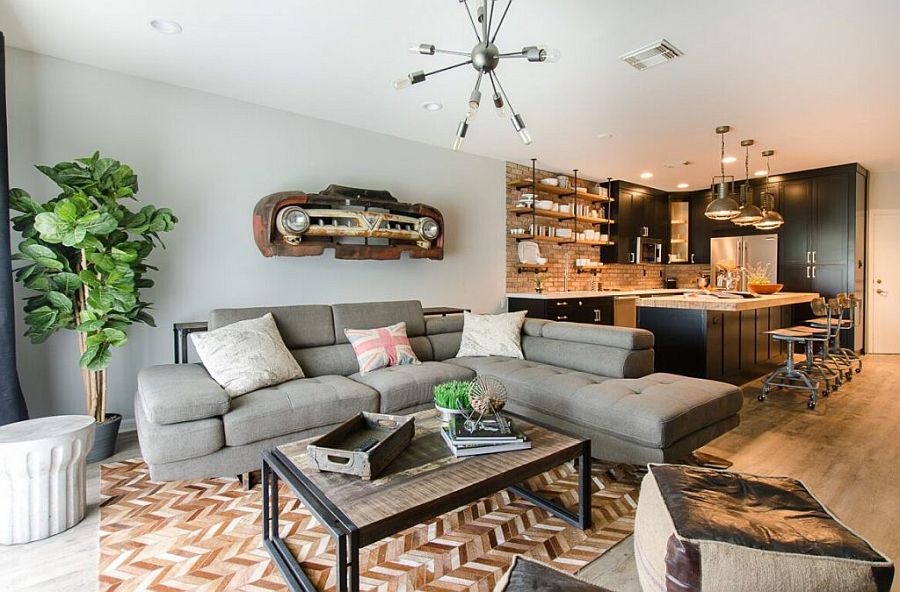 New open plan living area in gray and white with large sectional in light gray and chevron pattern floor