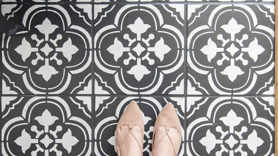 Painted ceramic floor tile in black and white