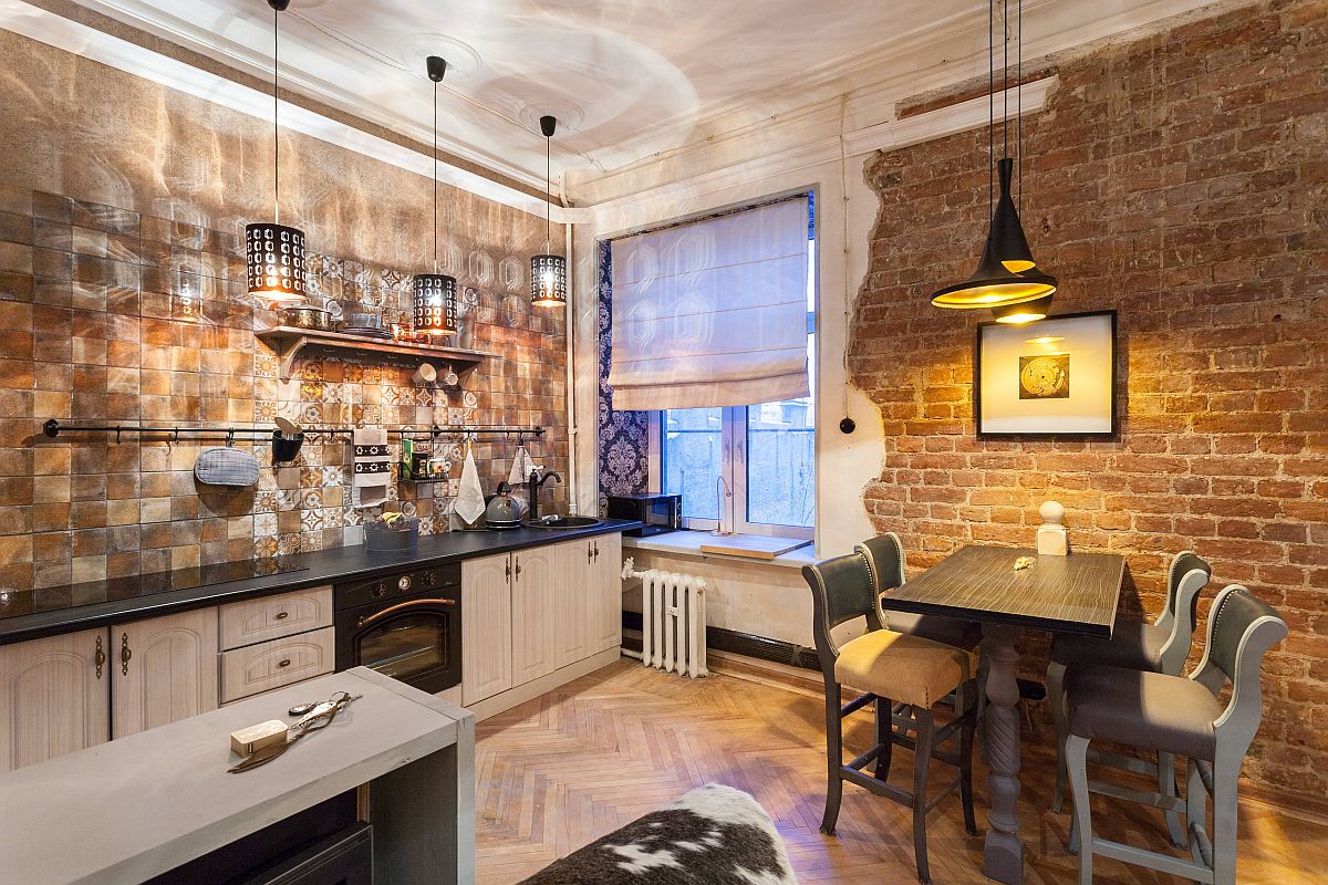 Pendants create a lovely interface between light and shadows in this brilliant industrial-eclectic kitchen