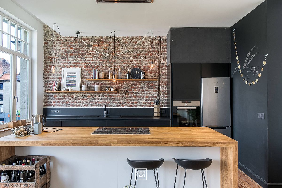 Polished gray finishes combined with exposed brick wall in the small modern-industrial kitchen