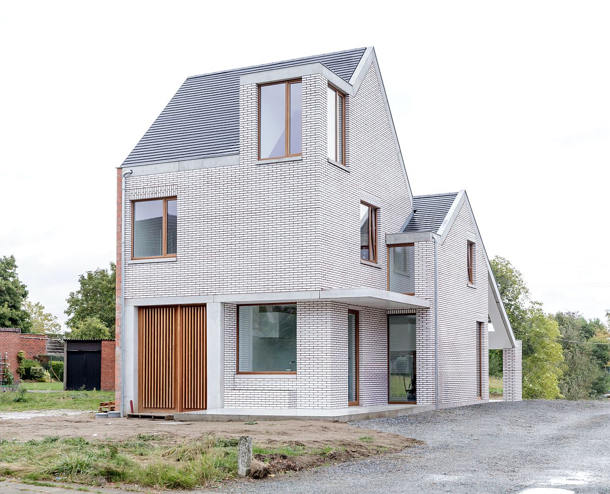 Red lines, white brick and a classic pitched roof give this Belgian home a modern-traditional look