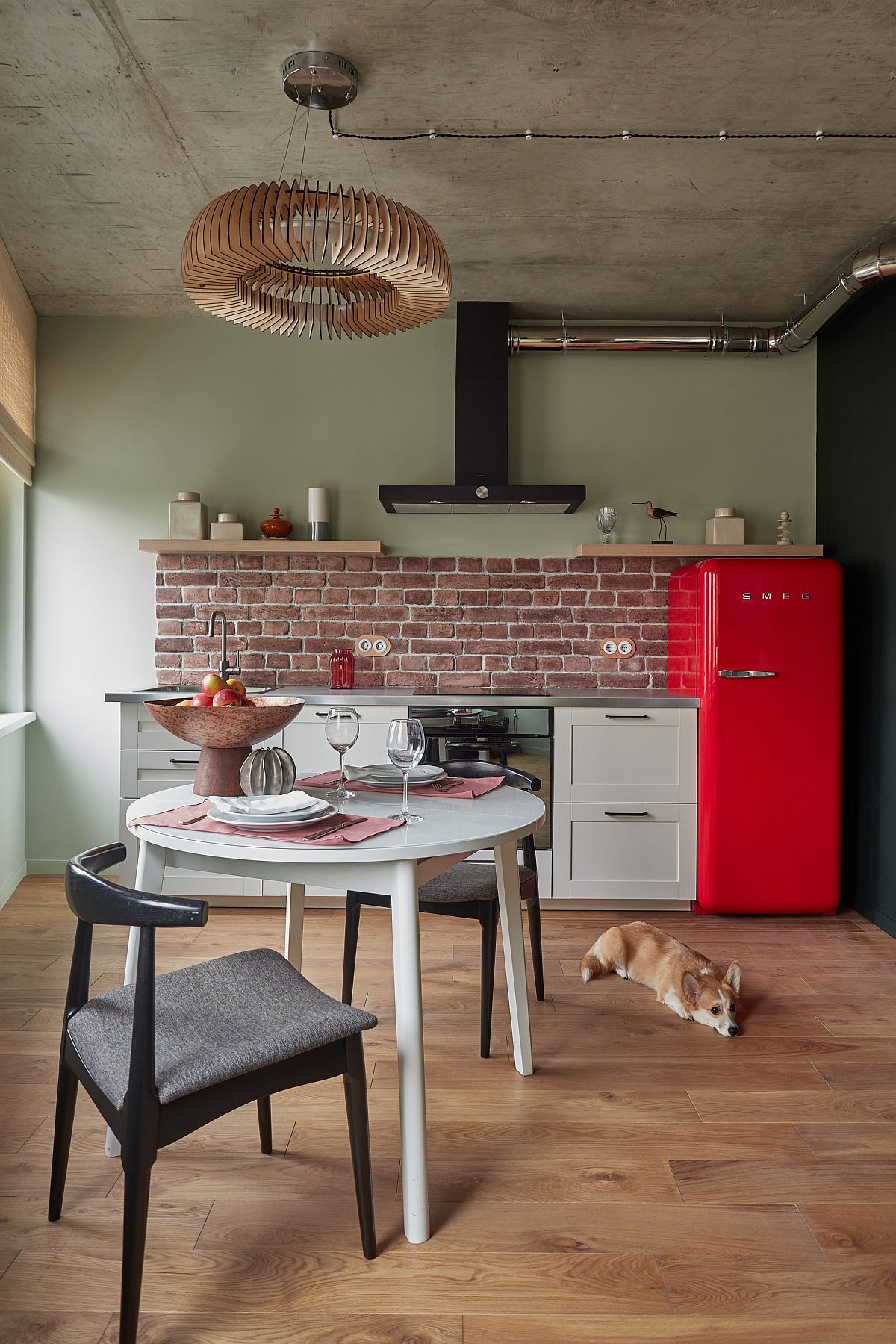 Red refrigerator brings color to this small industrial kitchen of Moscow apartment with retro touches