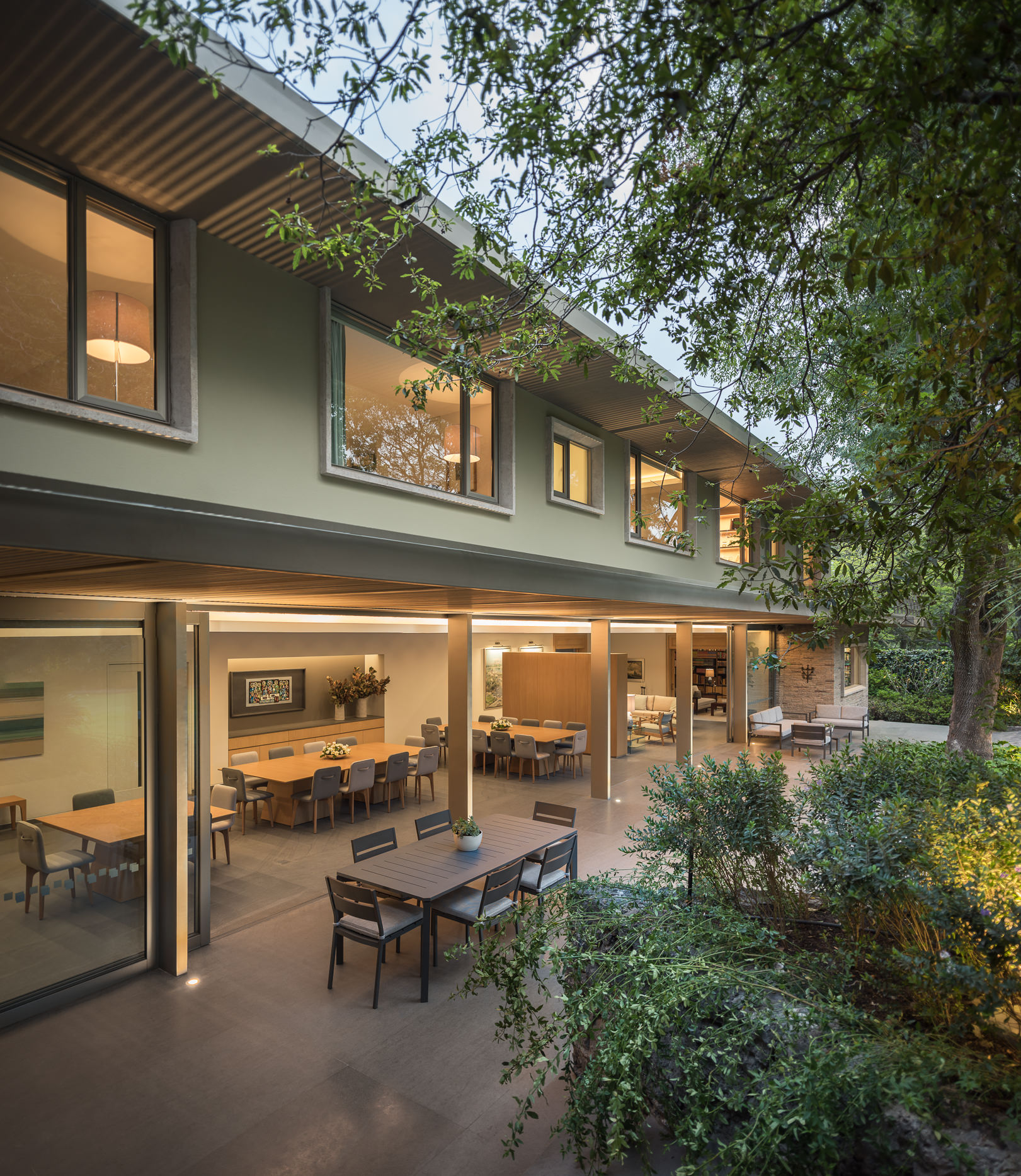 Series of sliding glass walls and windows completely open up the interior to the landscape outside