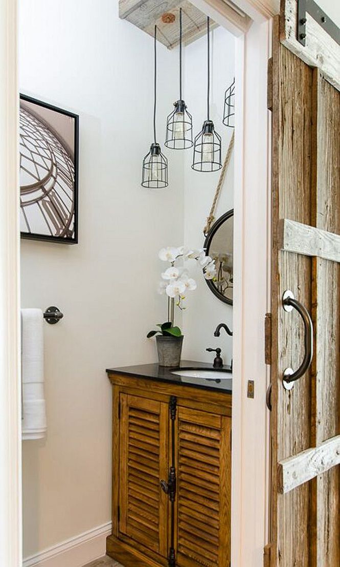Sliding barn style door for the small powder room with reclaimed vanity