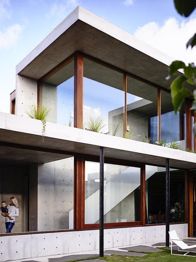 Sliding glass doors, concrete and greenery make the biggest impression inside this home