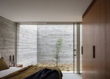 Sliding-glass-doors-connect-the-bedroom-and-the-small-garden-area-outside-67463-217x155