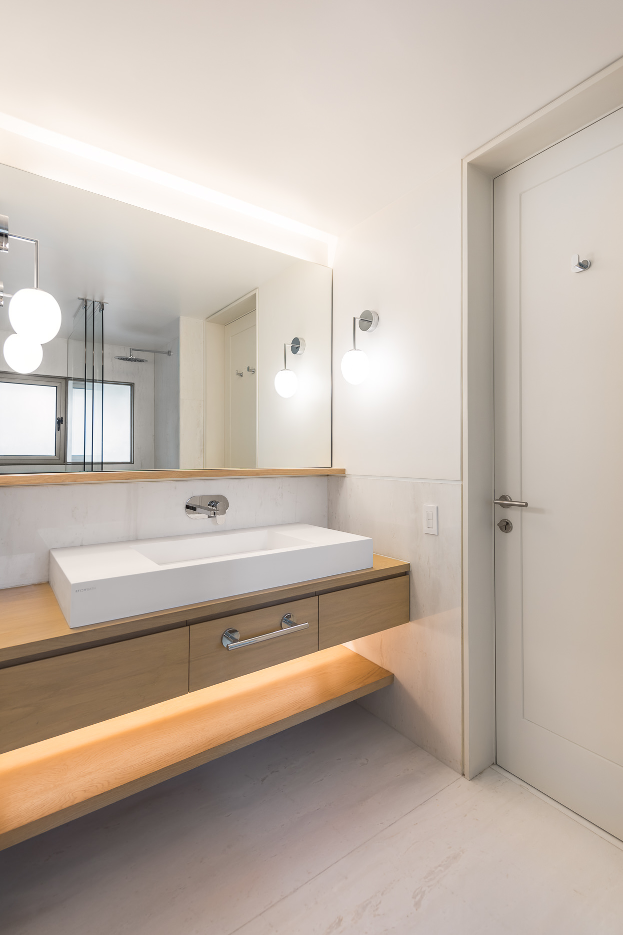 Slim wooden floating vanity along with strip LED lighting for the contemporary bathroom