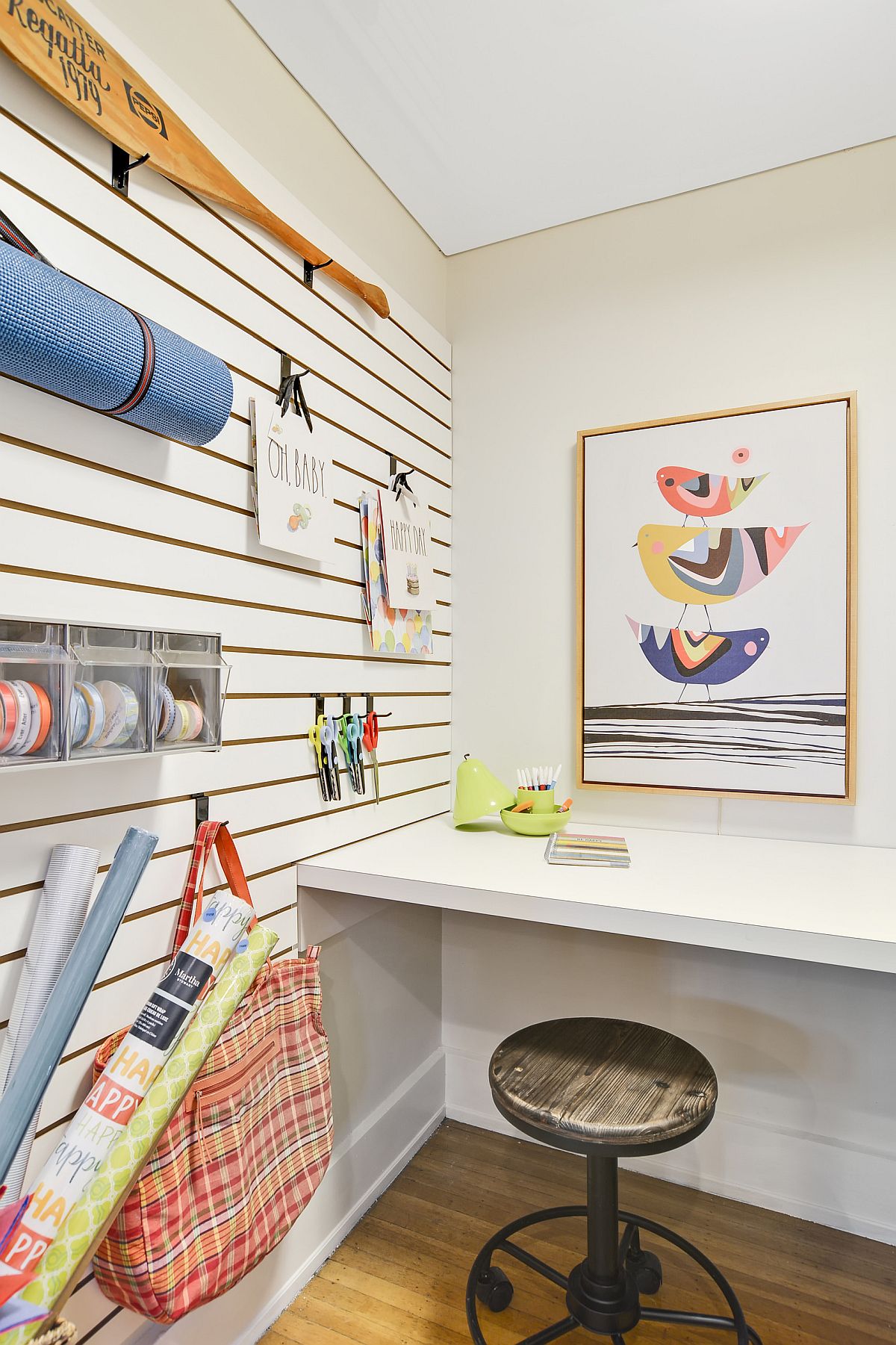 Small New York crafts room utilizes corner space along with storage benches under the counter