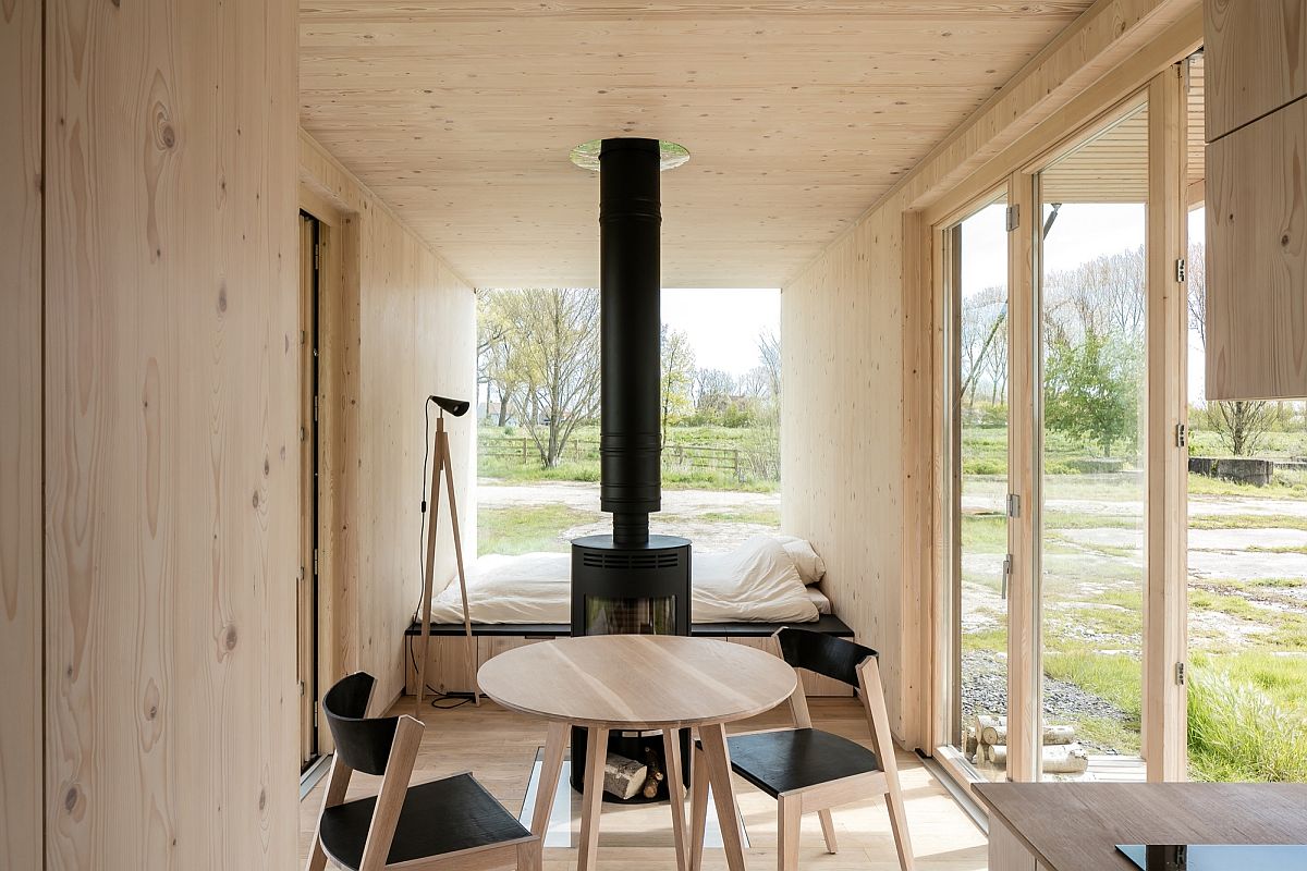 Small and space-savvy interior of the ARK shelter in wood that is used to shape the cabin interior