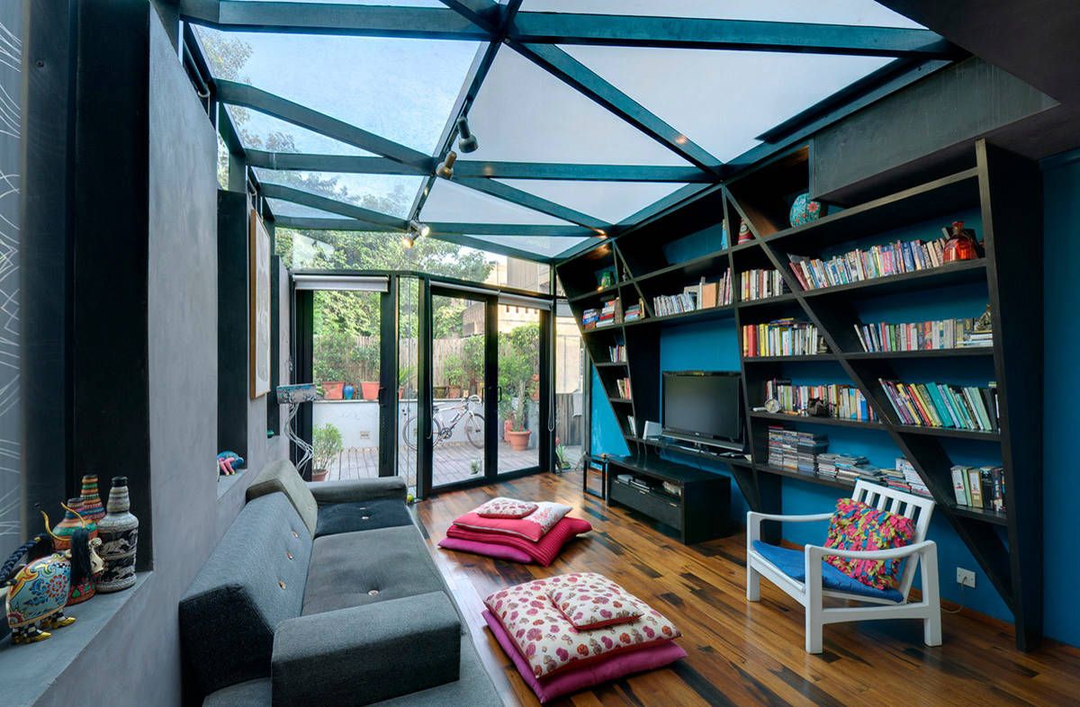 Small contemporary home library with glass roof, blue walls and innvotaive design