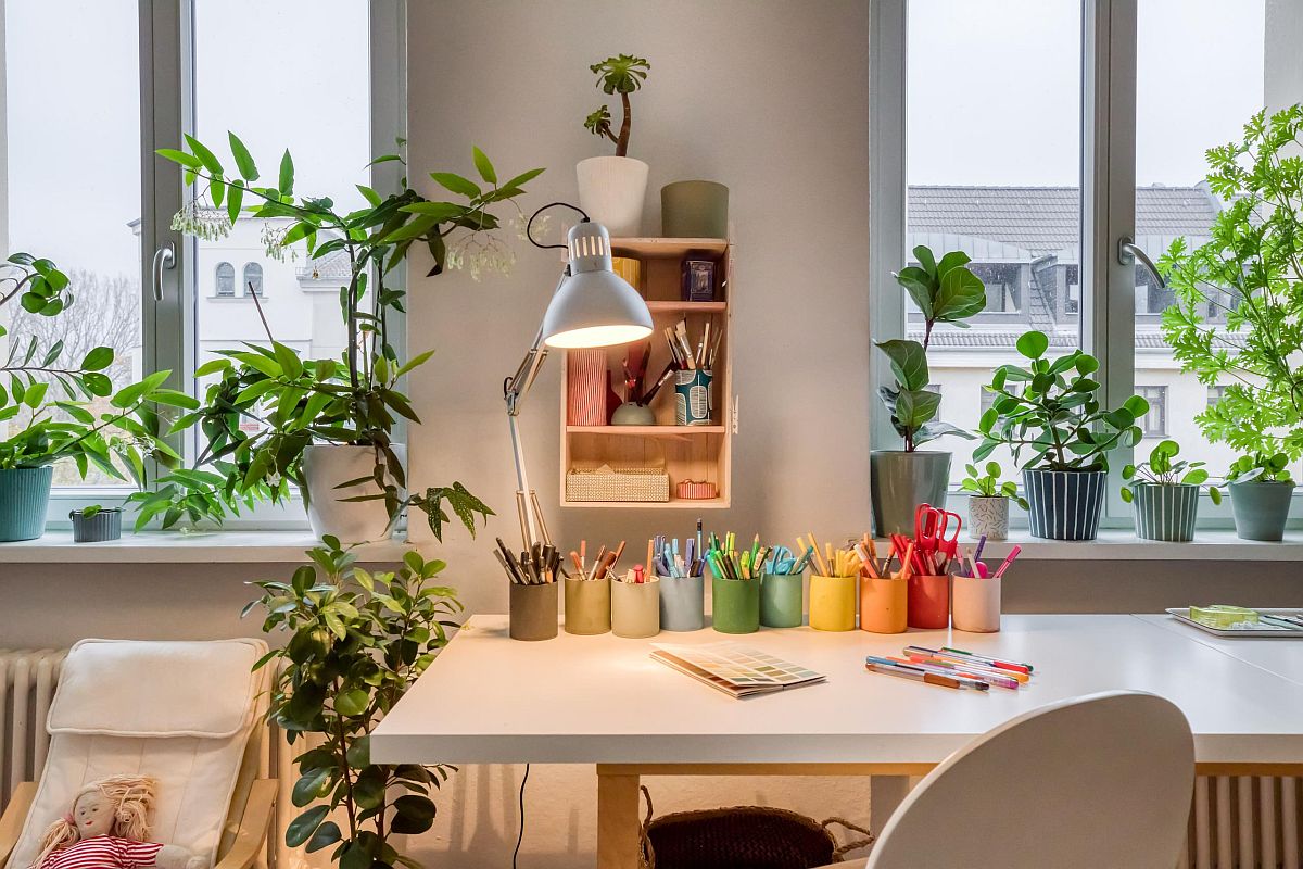 Smart freestanding desk for the Scandinavian style crafts room with plenty of natural light and a dash of greenery