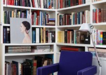 Turning-the-small-corner-in-the-modern-Victorian-home-into-a-library-with-bright-pink-rug-blue-chair-and-ample-shelving-53608-217x155