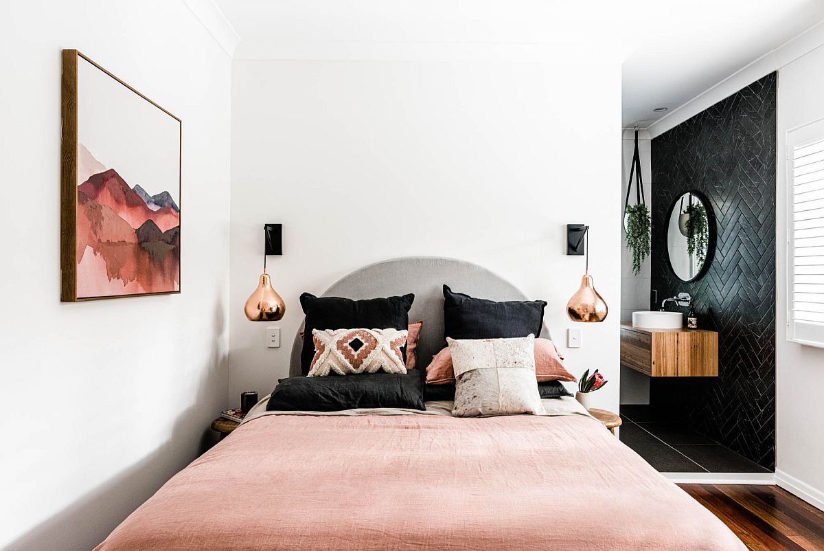 Wall art also adds color to the small Scandinavian style bedroom along with the bedsheets