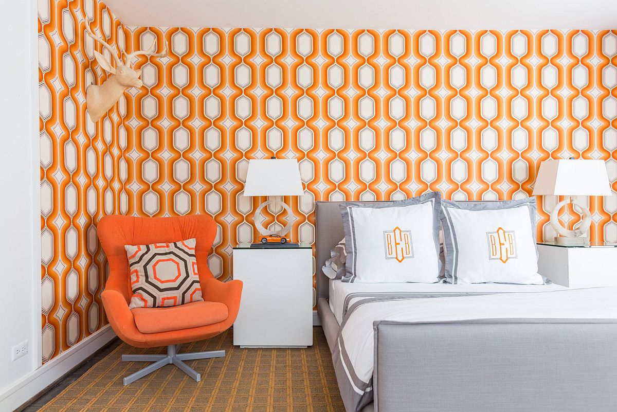 Wallpaper and chair bring in accent orange hue in here