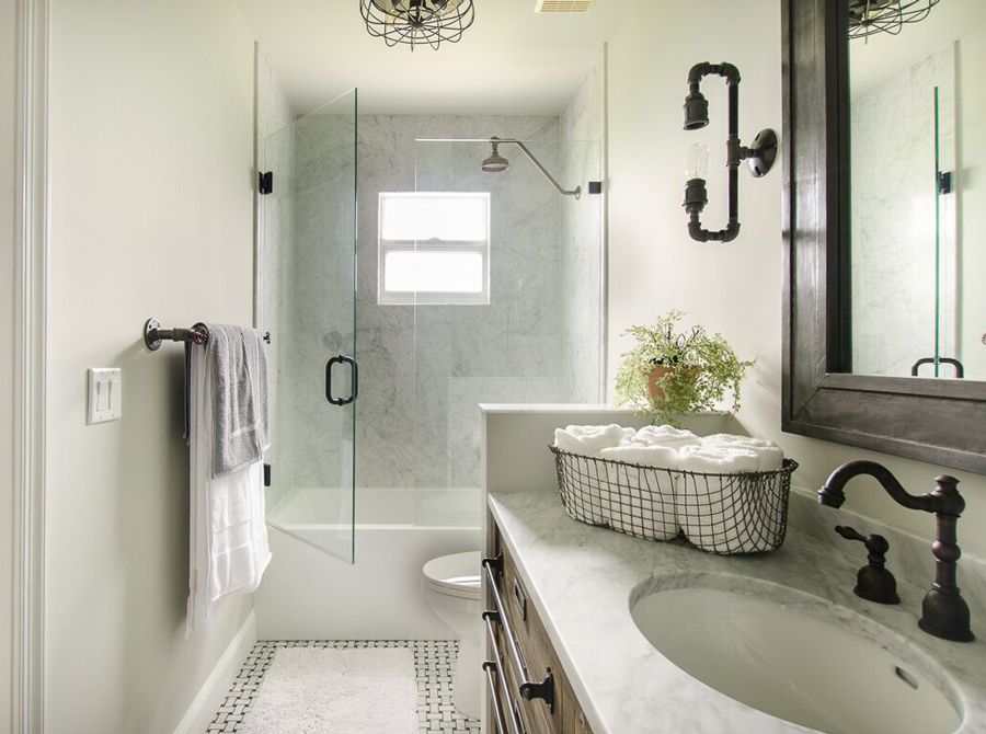 White modern industrial style bathroom with carrera marble in the backdrop