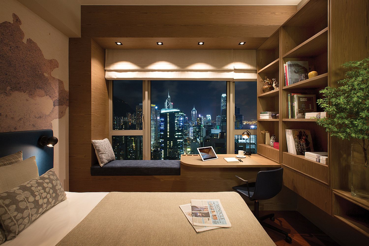 Window seat with a work desk and bookhelf next to it does more than offer just a reading zone