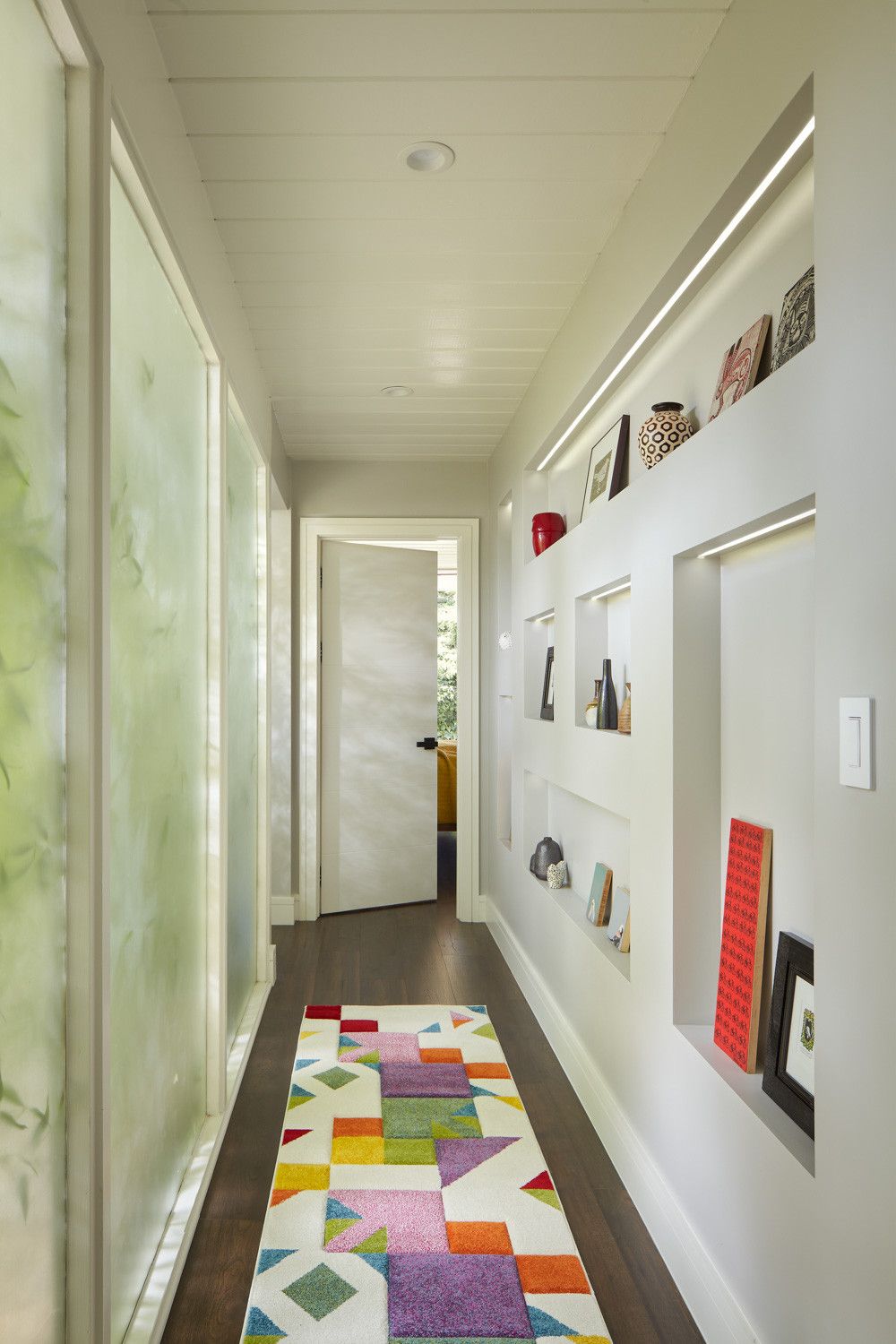 You do not need much shelf space to create a lovely display wall in the hallway