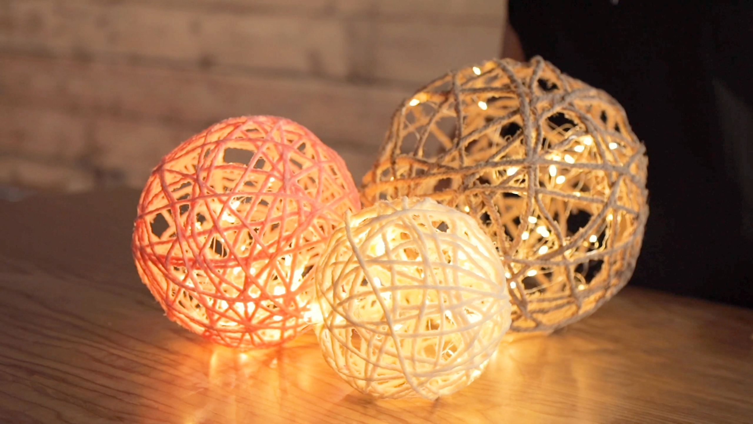 three different sized rope lanterns sitting on table