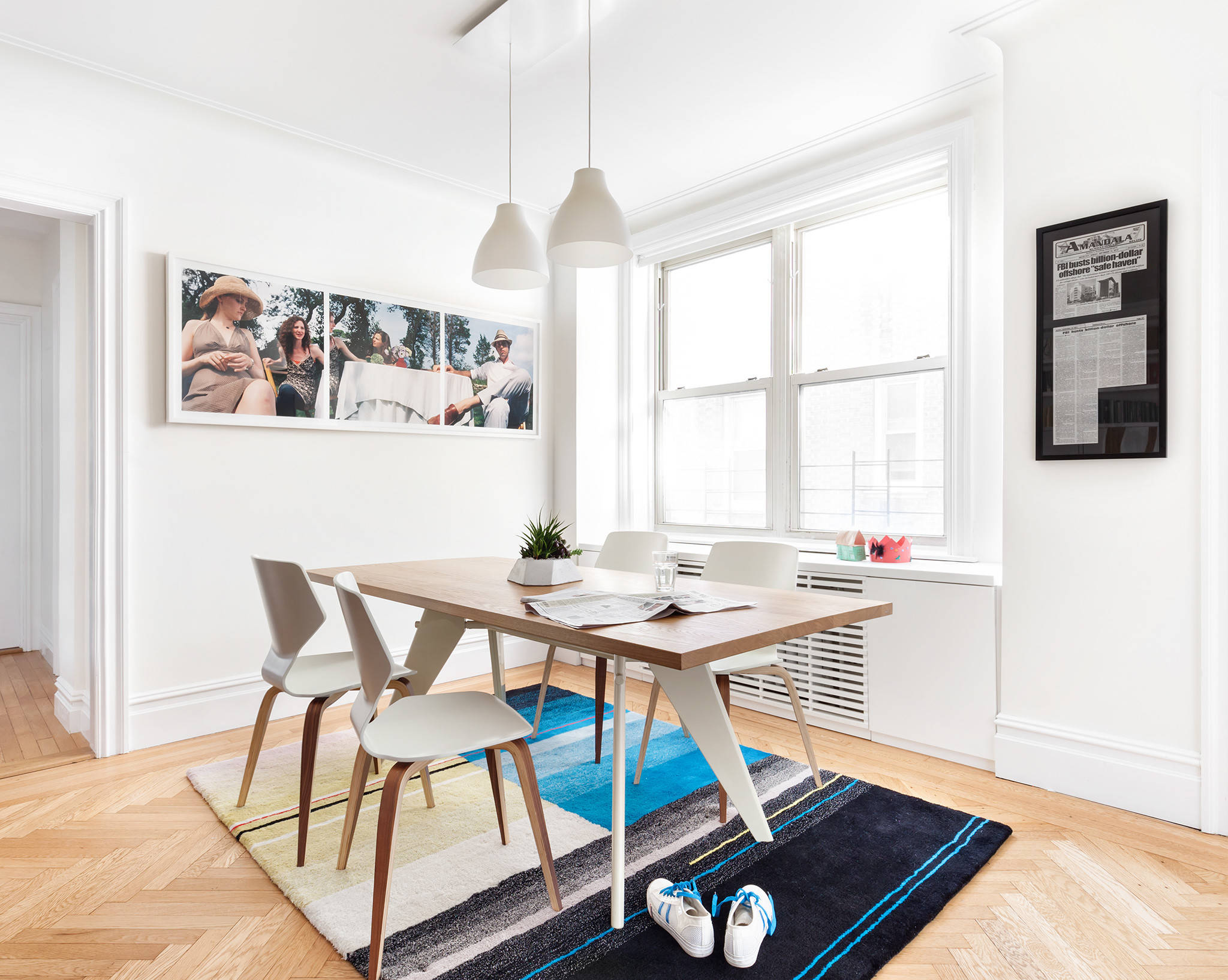 Add color to the small dining room in white with rug and wall art