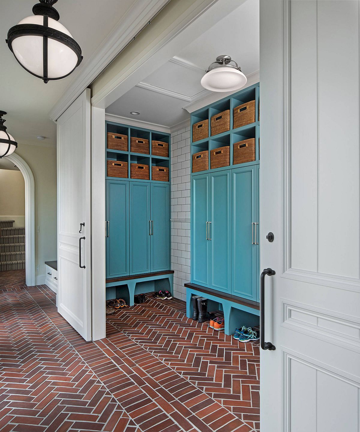 Brick floor in this modern entryway also adds herringbone pattern to the setting