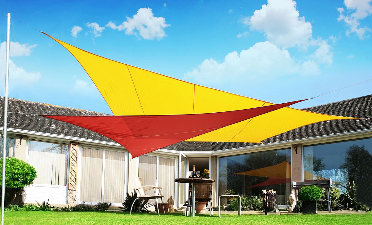 Brilliant and colorful use of sails to create shade for the backyard