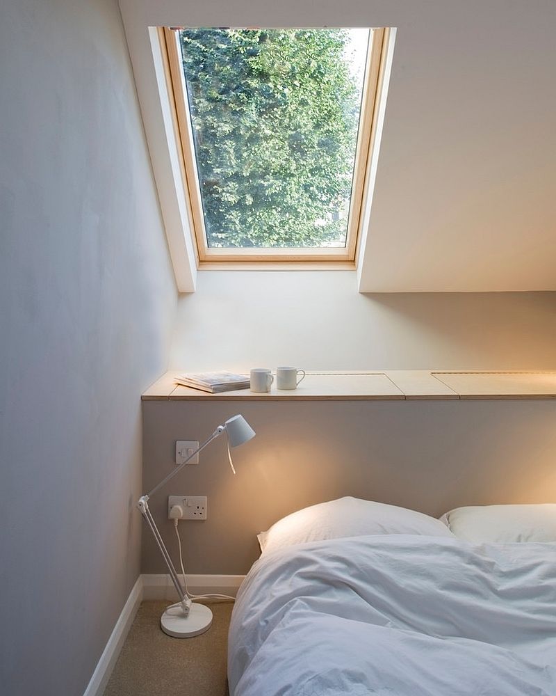 Built-in cabinets for the headboard wall provide storage in the small bedroom