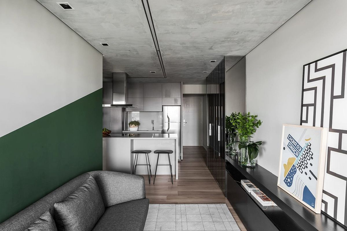 Burnt-cement-surfces-in-the-apartment-give-it-a-unique-appeal-while-green-brings-color-to-the-neutral-space-69055