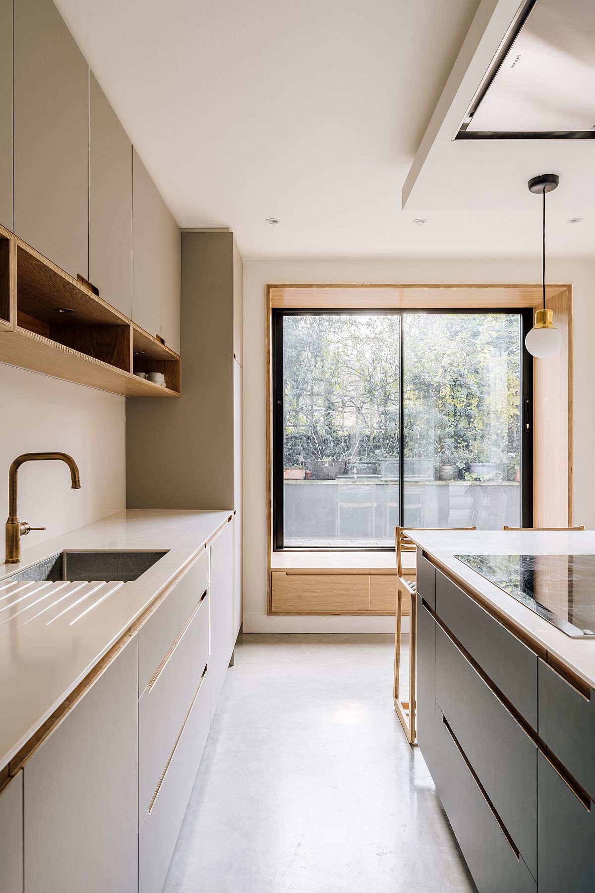 Custom oak window of the rear extension brings light into the modern kitchen