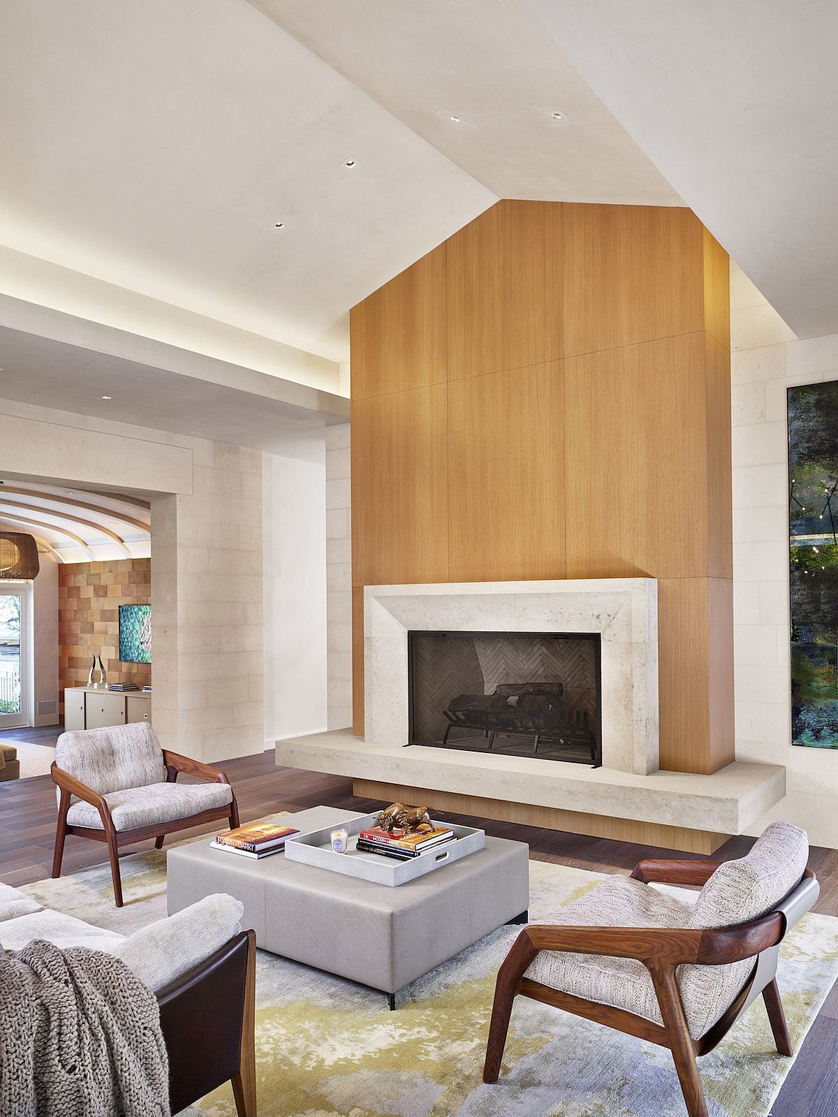 Custom wooden accent wall and fireplace become the focal point of this spacious modern minimal living room