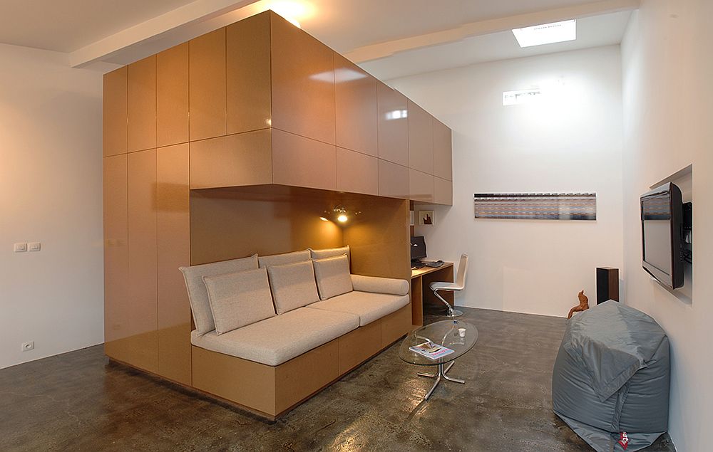 Custom wooden unit inside the garage turned into apartment contains sitting area and workspace