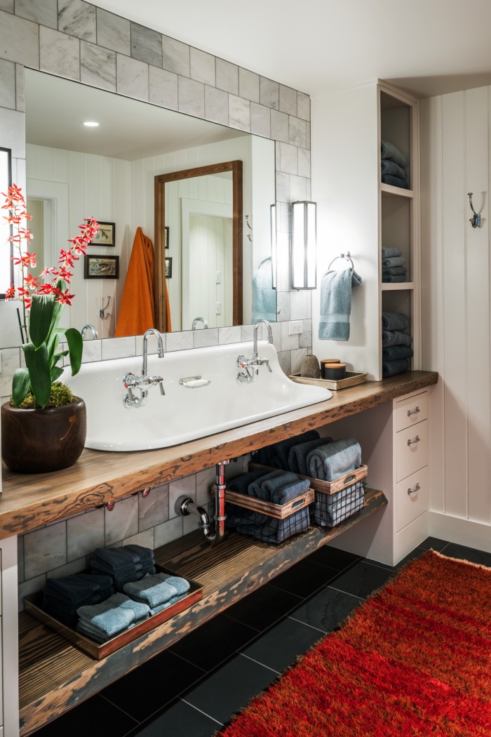 Custom wooden vanity in the white bathroom with plenty of storage space