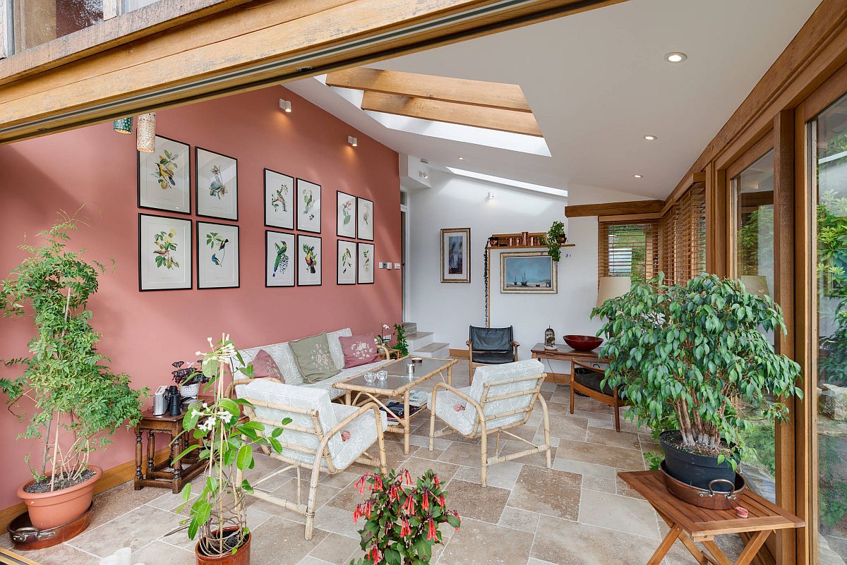 Decorating the modern spacious sunroom with indoor plants and botanicals on the wall