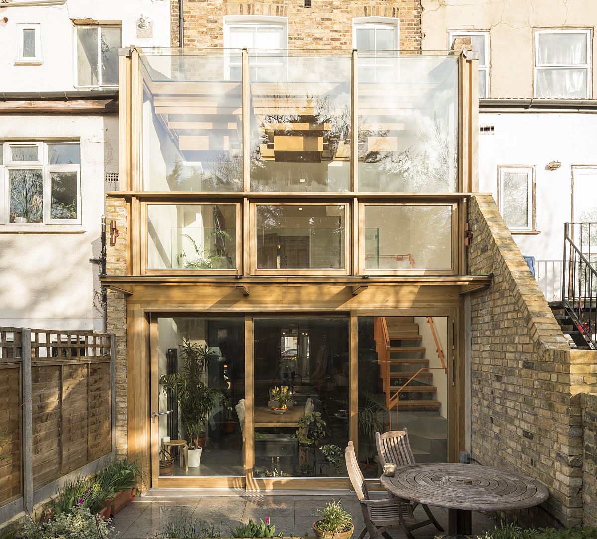 Double-height glazed extension in oak and glass transforms19th century home in UK