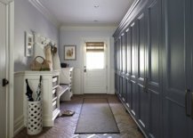 Entryway-of-New-York-home-with-light-blue-walls-dark-grayish-blue-cabinets-and-timeless-brick-floor-67792-217x155