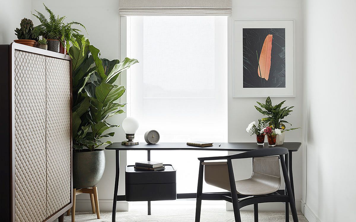 Exquisite modern home office in white with a dark gray desk and custom chair in matching hue