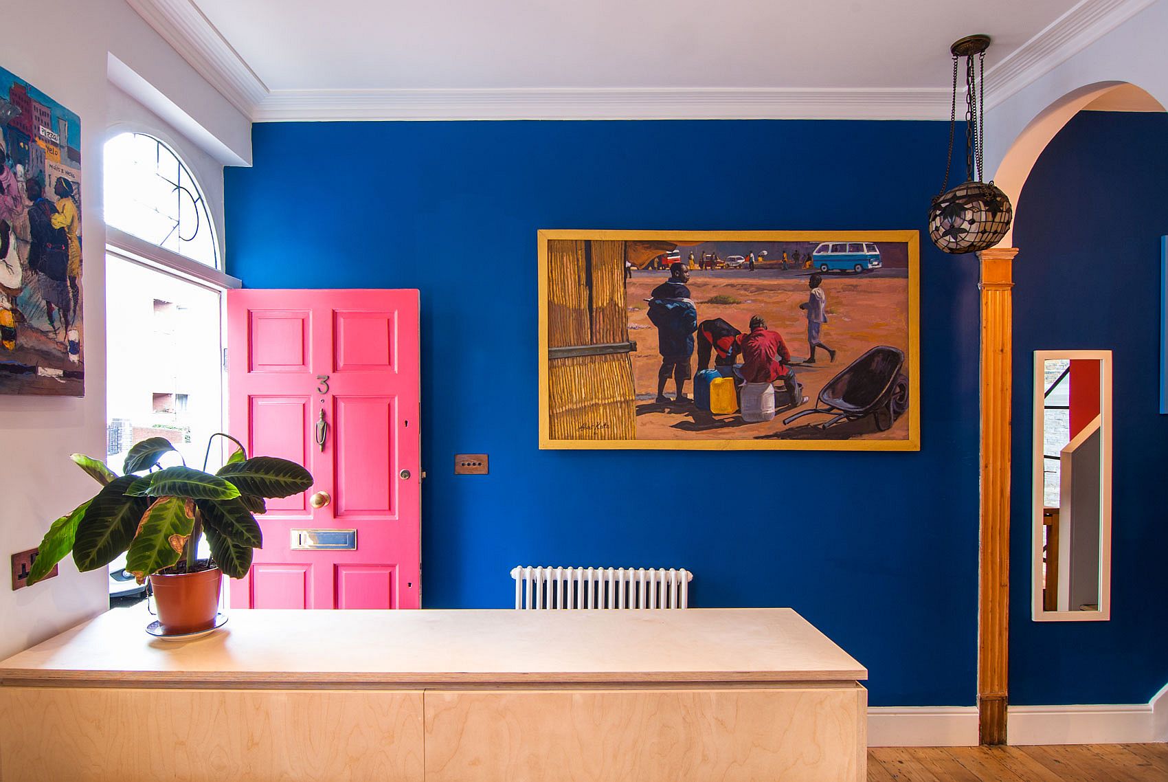 Eye-catching blend of dark blue, mustard yellow and lovely pink in the living room of the Steampunk house