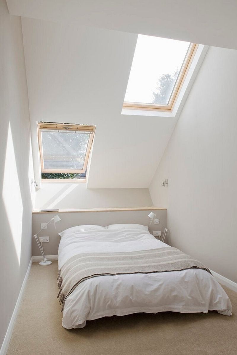 Fabulous bedroom in white with a hint of light gray along with a slanted ceiling and skylight