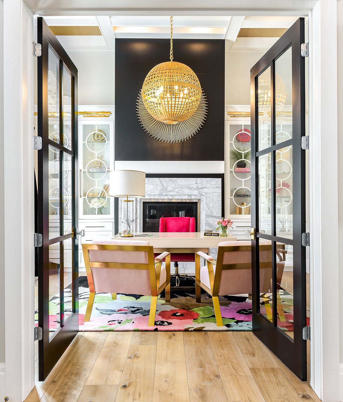 Fabulous transitional style home office with large framed glass doors and smart pops of color inside