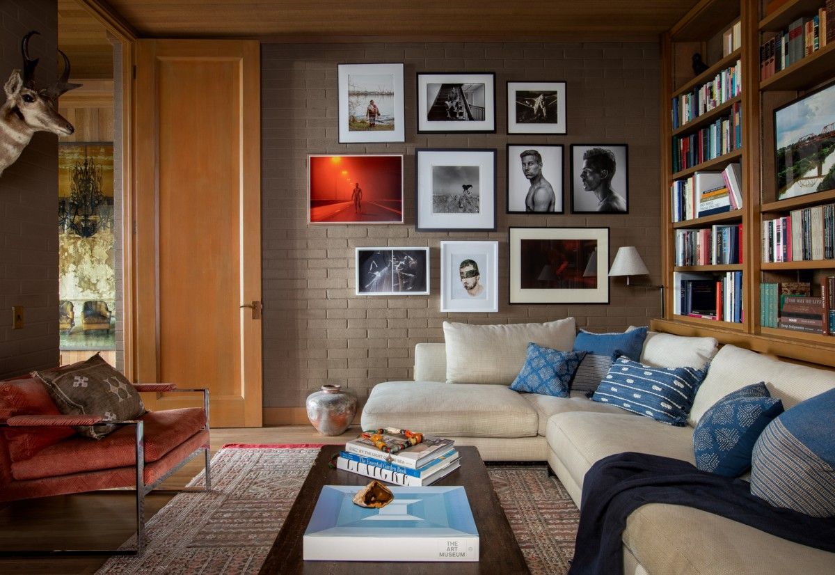 Family room with gallery wall on one side and bookshelves on the other