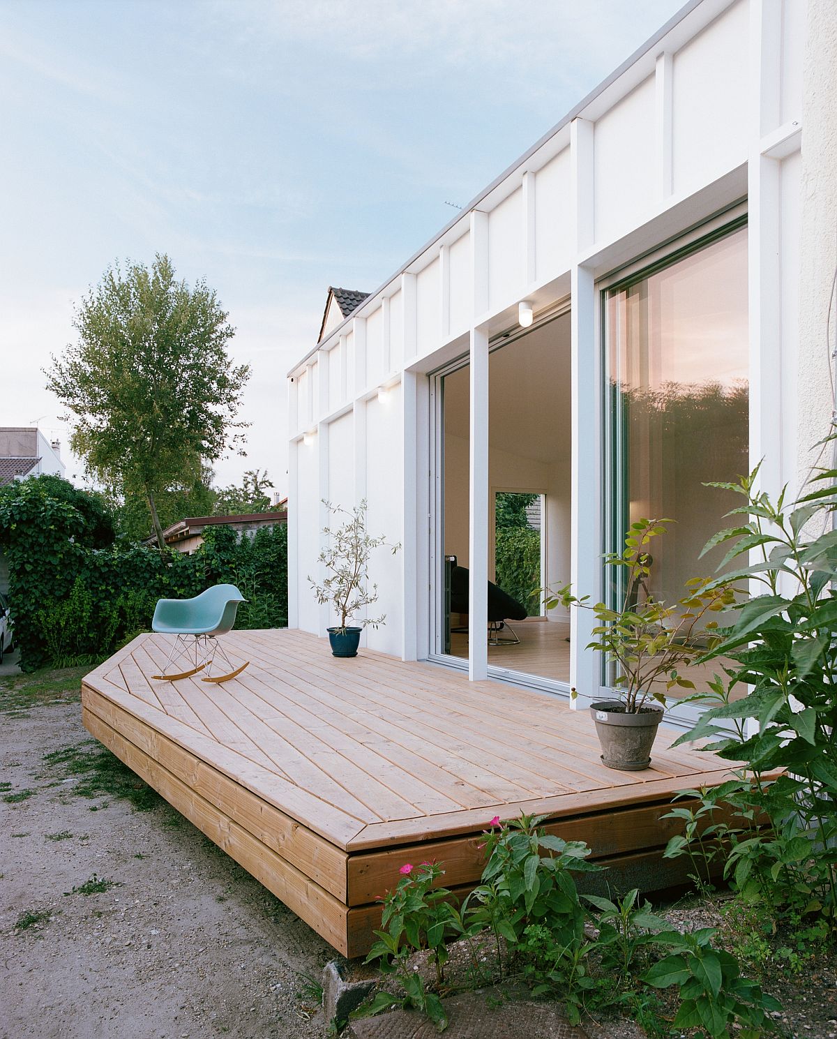 Glass doors connect the new living room with the small, open deck outside and extend the interior on summer days