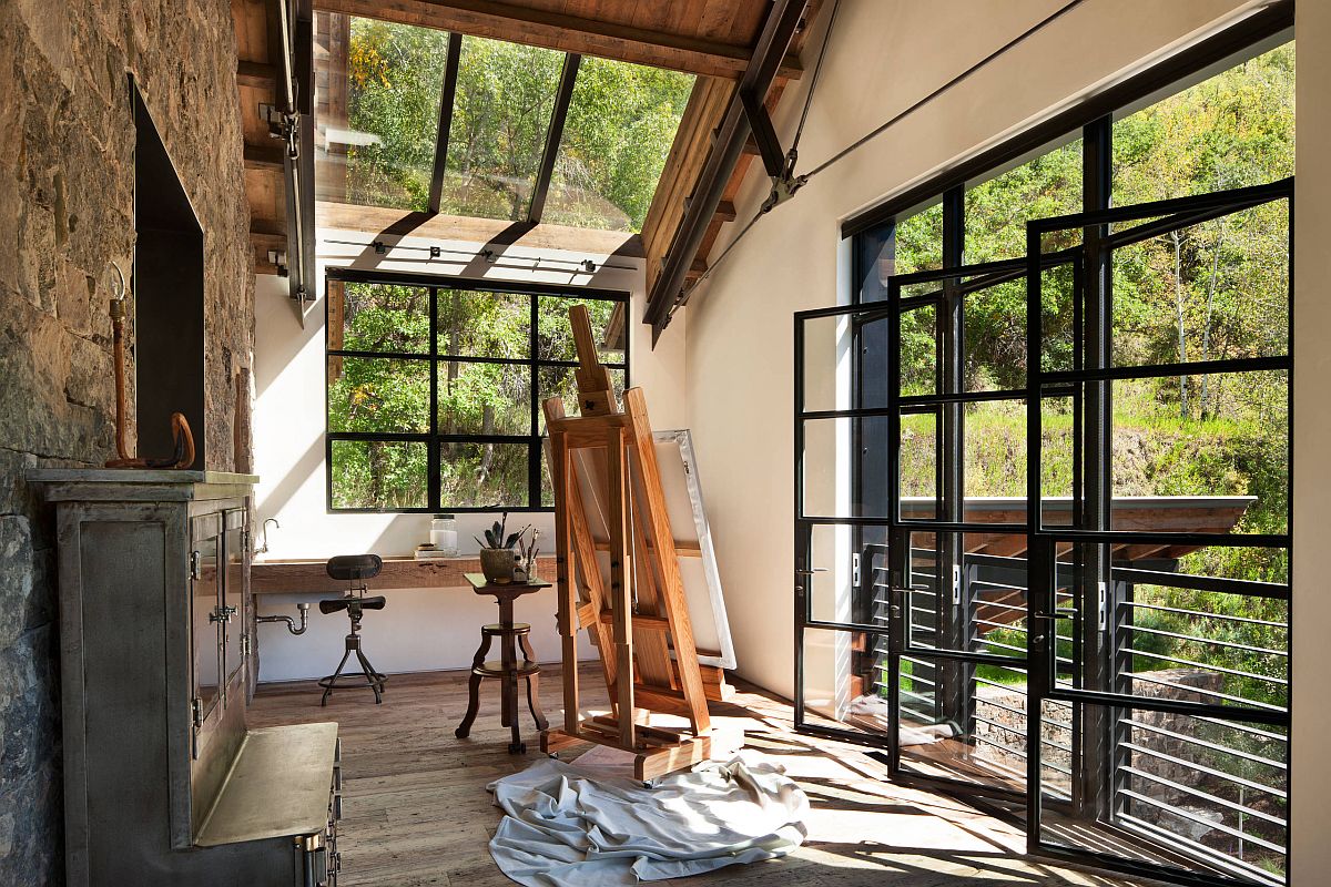 Glass walls, windows and skylights bring in the scenic view and light while keeping noise out of this rustic home office