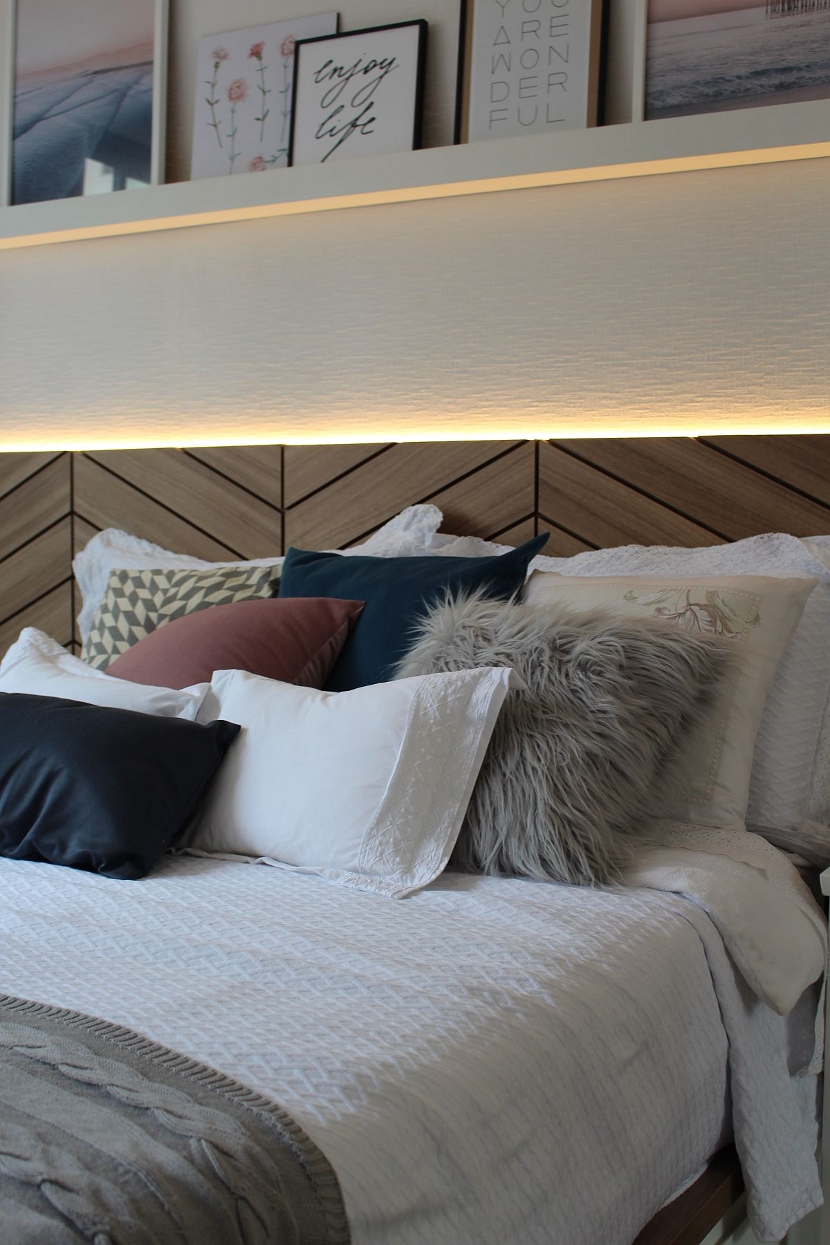 Gorgeous wood headboard with herringbone pattern and lovely LED strip lighting