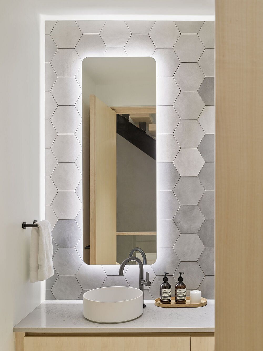 Gray-hexagonal-wall-tiles-bring-a-dash-of-visual-and-geometric-contrast-to-the-modern-wood-and-white-bathroom-37909